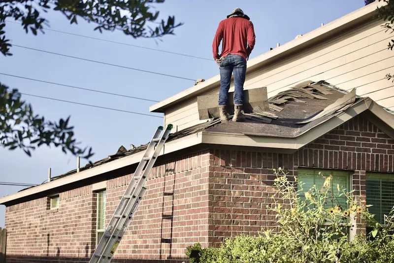 Professional roofer working on a residential roof in Franklin Park